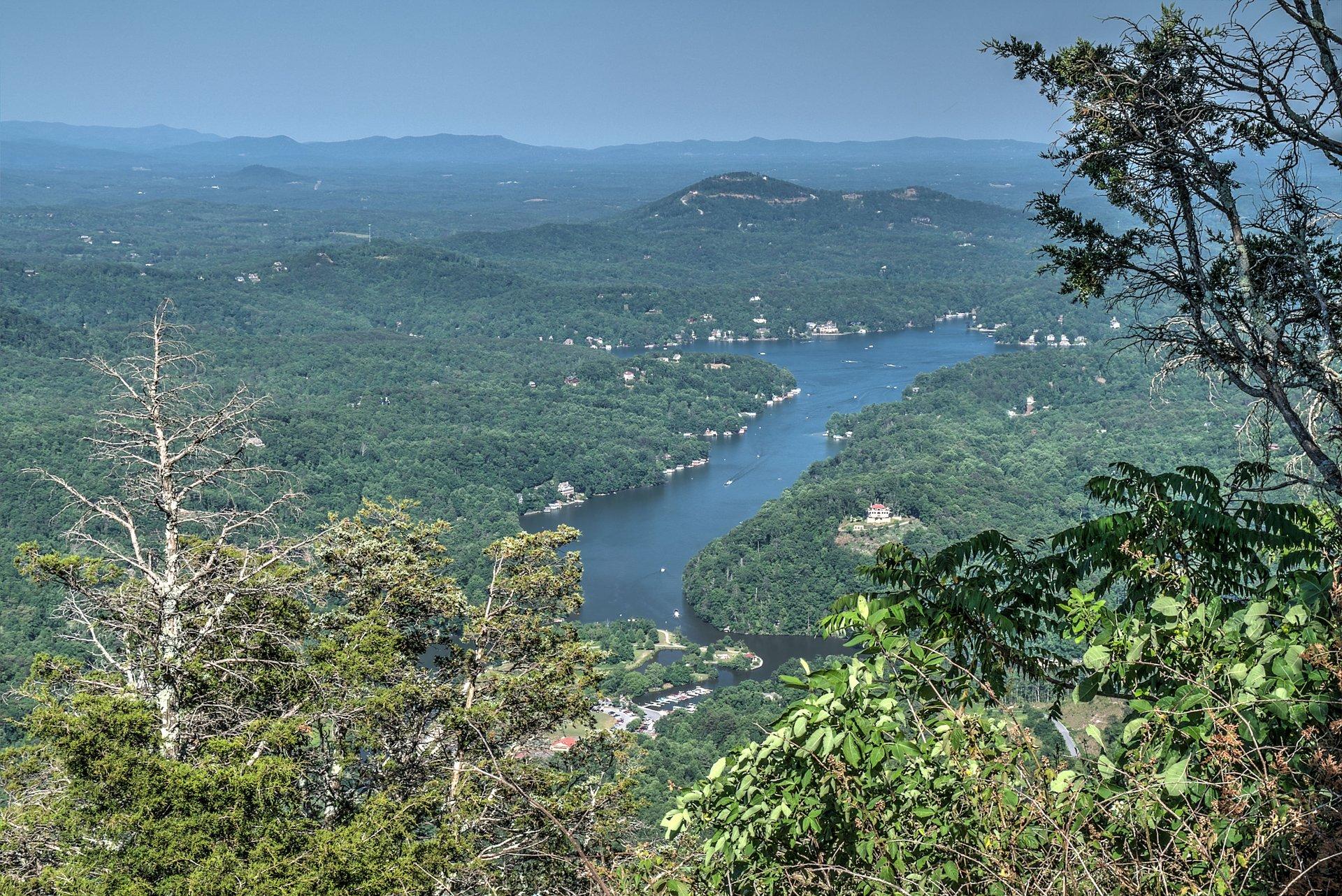 Lake Lure shoreline with blue water and forested mountains in the background